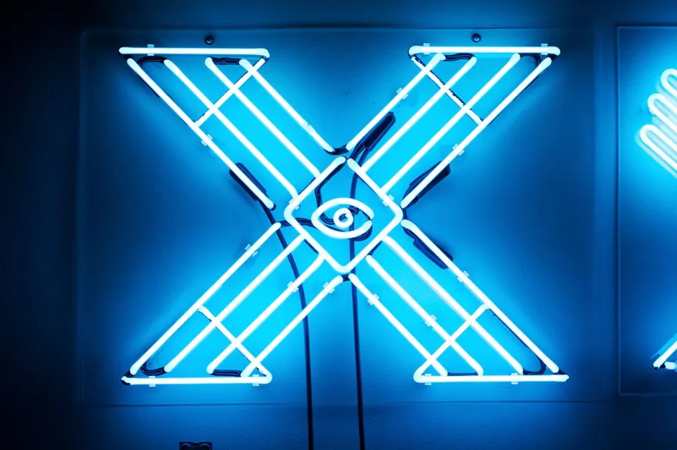 Close-up of intricate white neon letter X